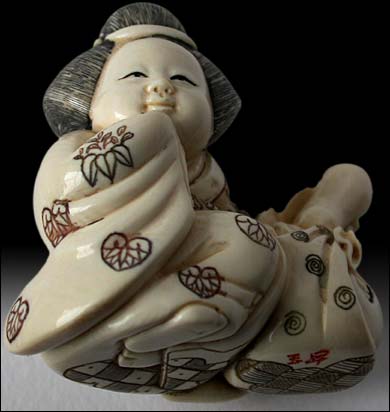 Okame Netsuke sig Gyokusho