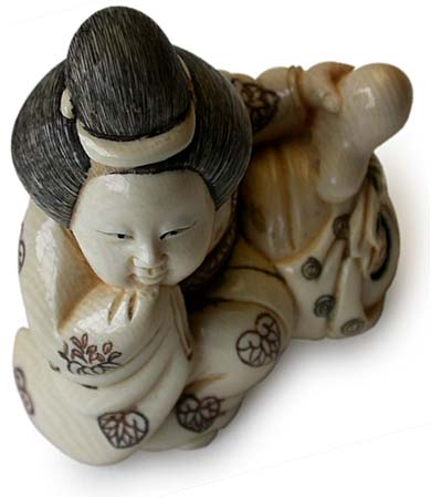 Okame Playing Tengu Netsuke
