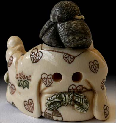 Okame Playing Tengu Netsuke back